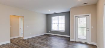 The living room of a new home with a door and window
